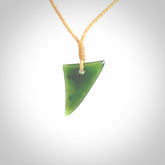 This is a lovely New Zealand Jade, pounamu niho drop pendant. Hand carved for us by Ric Moor. It is bound with an adjustable beige coloured cord which is length adjustable. Free worldwide shipping.